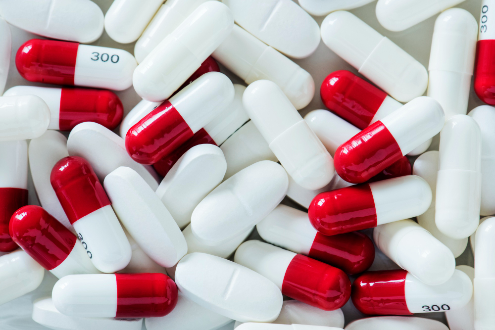 Red and white pharmaceutical capsules with number markings