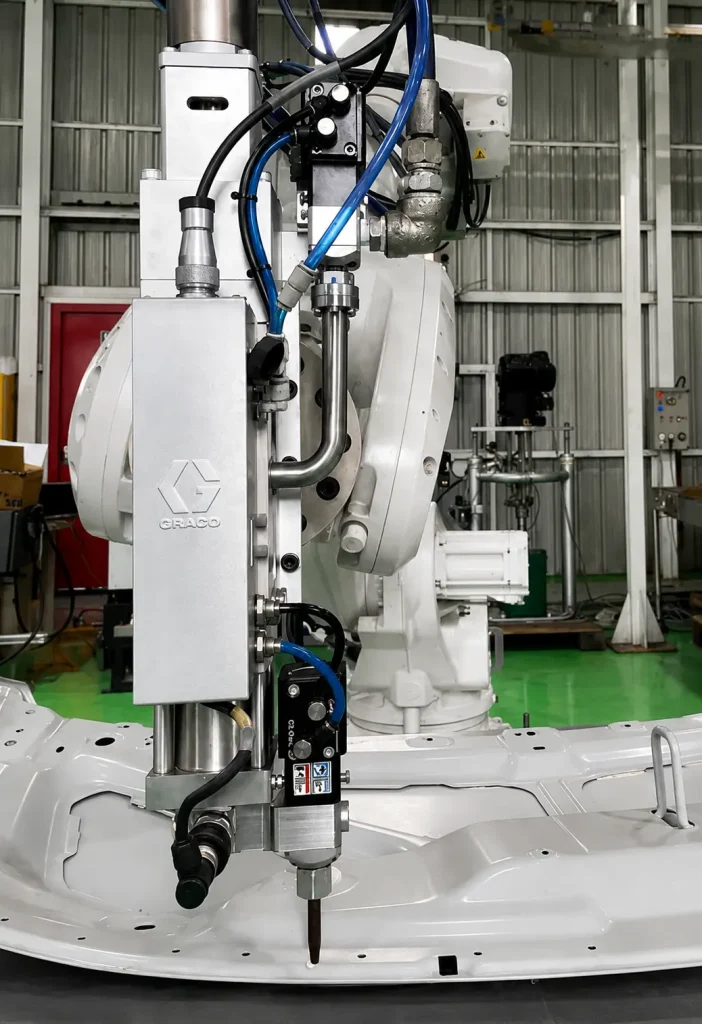 Industrial robot arm with pneumatic gripper and blue tubing