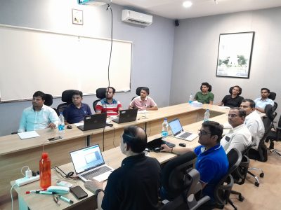 A few members of the team are sitting in a meeting.