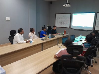 A few members of the team are watching the screen.